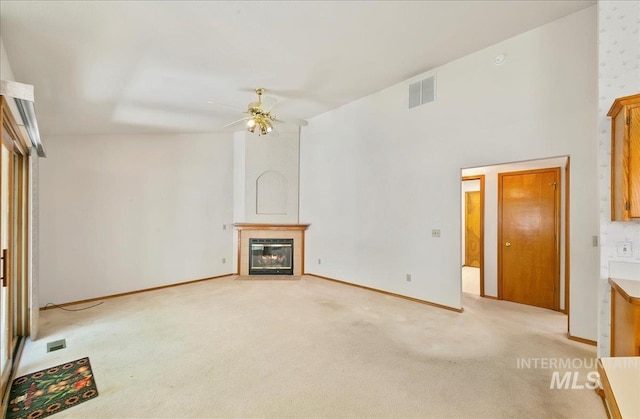 900 N Player Ave, Eagle, ID 83616 - unfurnished living room with light carpet, ceiling fan, a tile fireplace, and baseboards