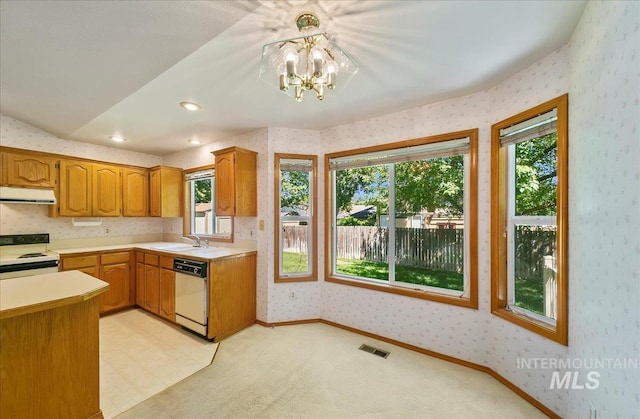 900 N Player Ave, Eagle, ID 83616 - kitchen with white appliances, range hood, wallpapered walls, light countertops, and plenty of natural light
