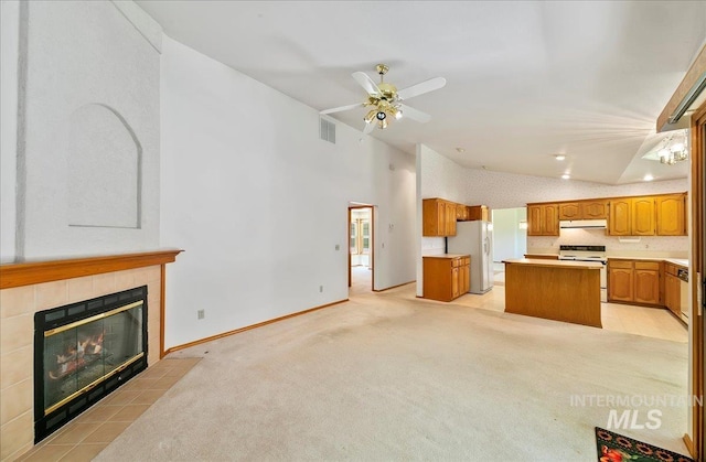900 N Player Ave, Eagle, ID 83616 - unfurnished living room with a fireplace, a ceiling fan, light colored carpet, vaulted ceiling, and baseboards