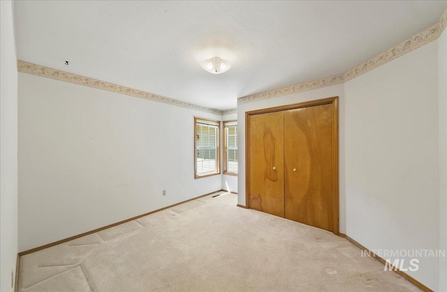 900 N Player Ave, Eagle, ID 83616 - unfurnished bedroom featuring baseboards, light carpet, and a closet