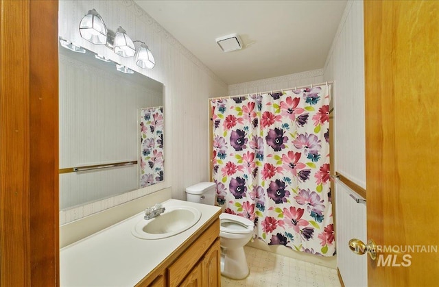900 N Player Ave, Eagle, ID 83616 - bathroom with toilet, tile patterned floors, vanity, wallpapered walls, and curtained shower