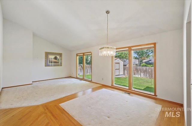 900 N Player Ave, Eagle, ID 83616 - unfurnished room with a chandelier, vaulted ceiling, baseboards, and light wood-type flooring