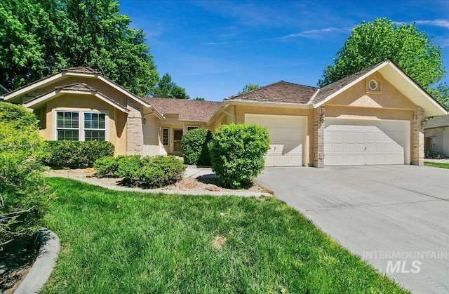 900 N Player Ave, Eagle, ID 83616 - single story home with an attached garage, concrete driveway, brick siding, stucco siding, and a front yard