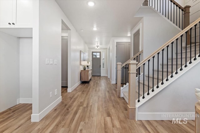 foyer featuring stairway, recessed lighting, light wood-style flooring, and baseboards