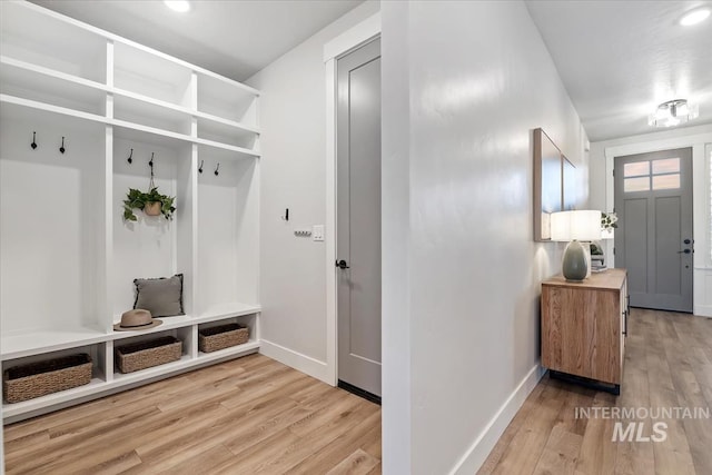 mudroom with wood finished floors and baseboards