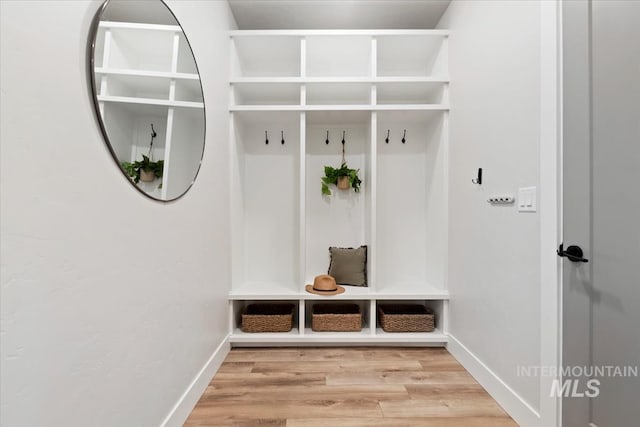 mudroom featuring light wood-style floors and baseboards