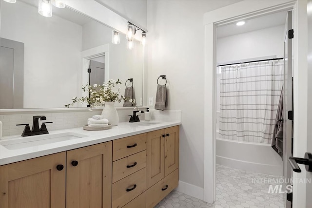 full bath with double vanity, a sink, decorative backsplash, and tile patterned floors