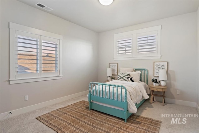 carpeted bedroom with baseboards and visible vents