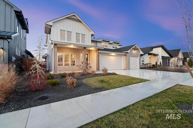 view of front of home featuring board and batten siding, concrete driveway, brick siding, and an attached garage