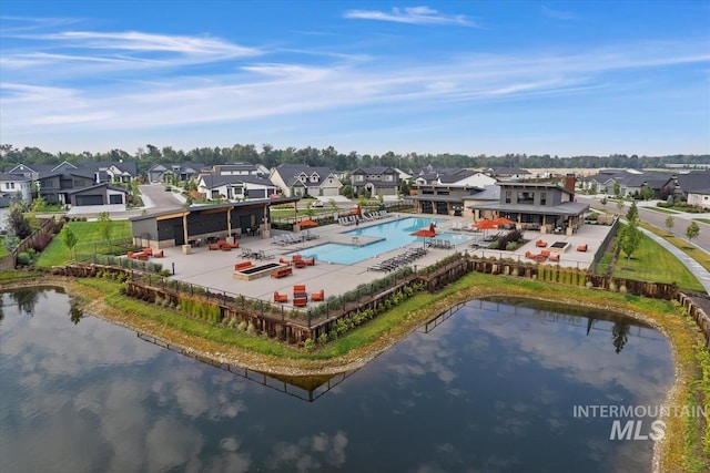 birds eye view of property with a water view and a residential view