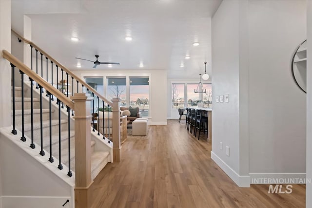 entrance foyer with ceiling fan, recessed lighting, wood finished floors, baseboards, and stairs