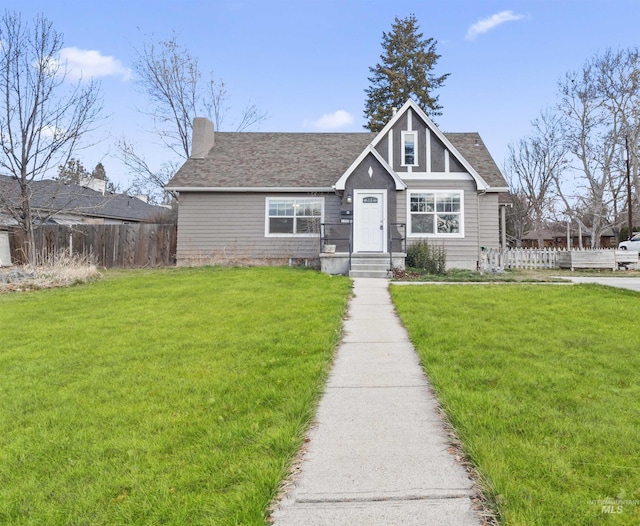 3500 W Overland, Boise, ID 83705 - view of front facade with a shingled roof, fence, and a front lawn