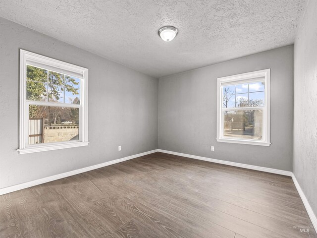 3500 W Overland, Boise, ID 83705 - empty room with baseboards, wood finished floors, and a textured ceiling