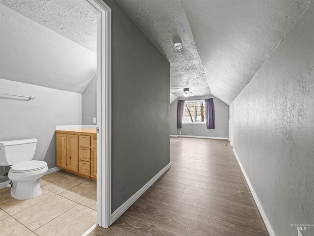 3500 W Overland, Boise, ID 83705 - interior space featuring toilet, wood finished floors, baseboards, and a textured ceiling