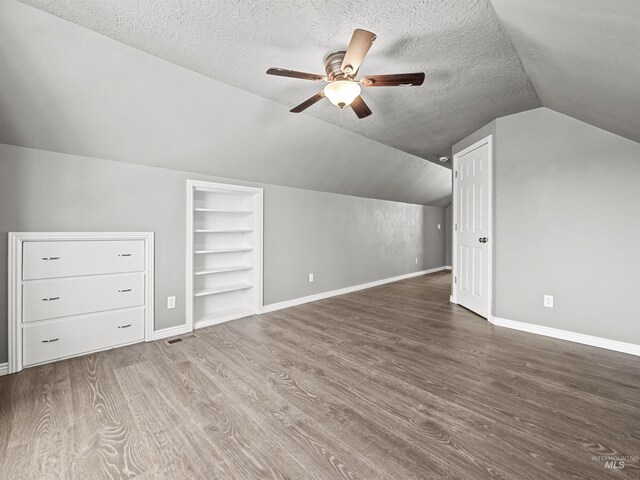3500 W Overland, Boise, ID 83705 - additional living space featuring built in features, a textured ceiling, wood finished floors, and a ceiling fan
