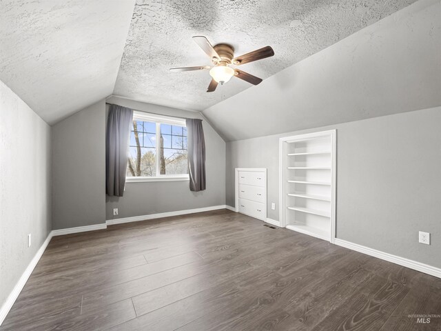 3500 W Overland, Boise, ID 83705 - additional living space featuring built in features, a textured ceiling, dark wood-type flooring, and ceiling fan