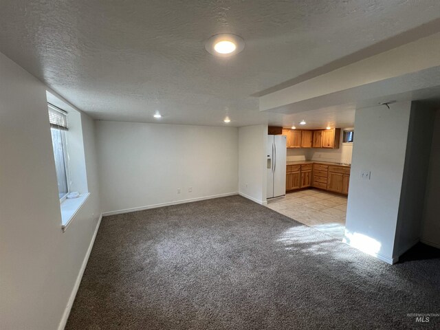 3500 W Overland, Boise, ID 83705 - unfurnished living room with light colored carpet, baseboards, and a textured ceiling