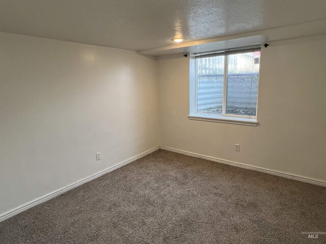 3500 W Overland, Boise, ID 83705 - empty room with baseboards and dark carpet