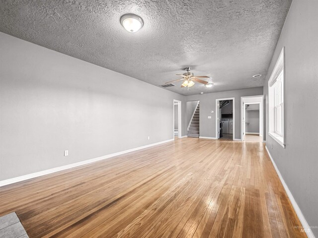 3500 W Overland, Boise, ID 83705 - unfurnished living room featuring stairs, a textured ceiling, light wood-style flooring, baseboards, and ceiling fan