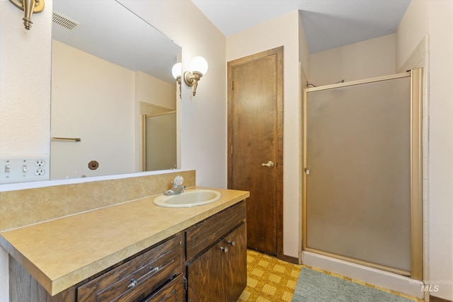 bathroom with vanity, tile patterned floors, visible vents, and a shower stall