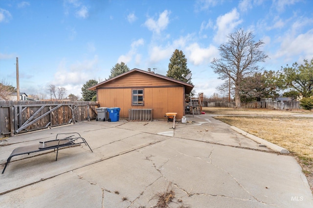 rear view of property featuring a patio area and fence