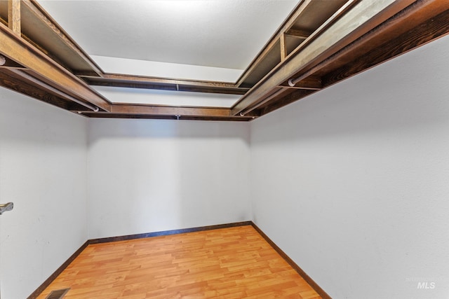 spacious closet with light wood-style floors and visible vents