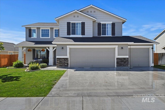 view of front facade featuring a garage, covered porch, and a front yard