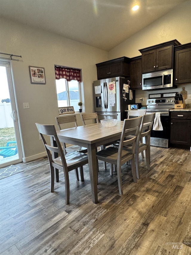 dining area with lofted ceiling, plenty of natural light, and wood-type flooring