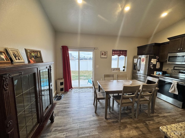 dining space with dark hardwood / wood-style floors and lofted ceiling