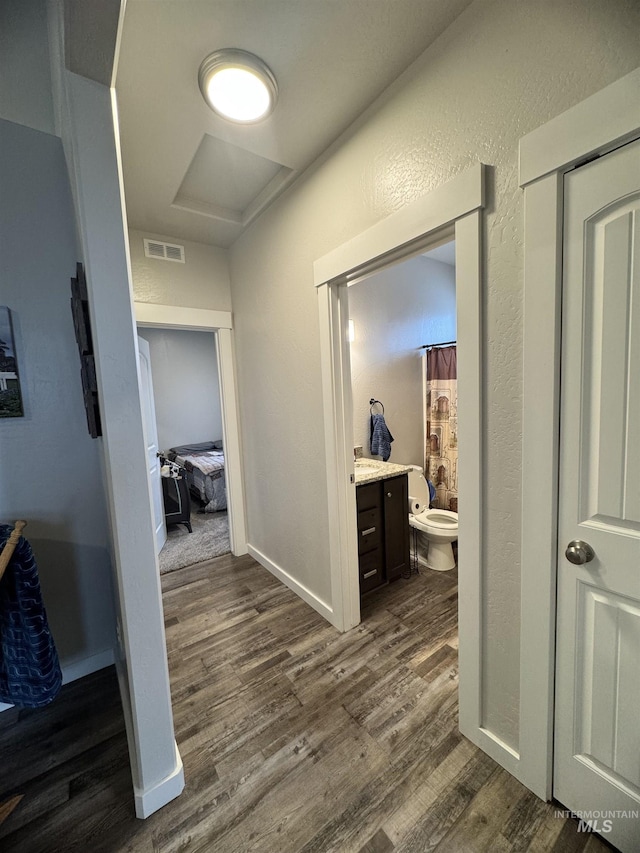 hallway featuring dark hardwood / wood-style flooring