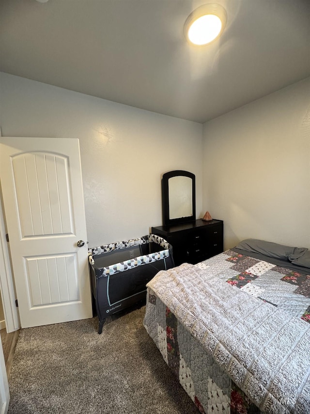 bedroom with dark colored carpet