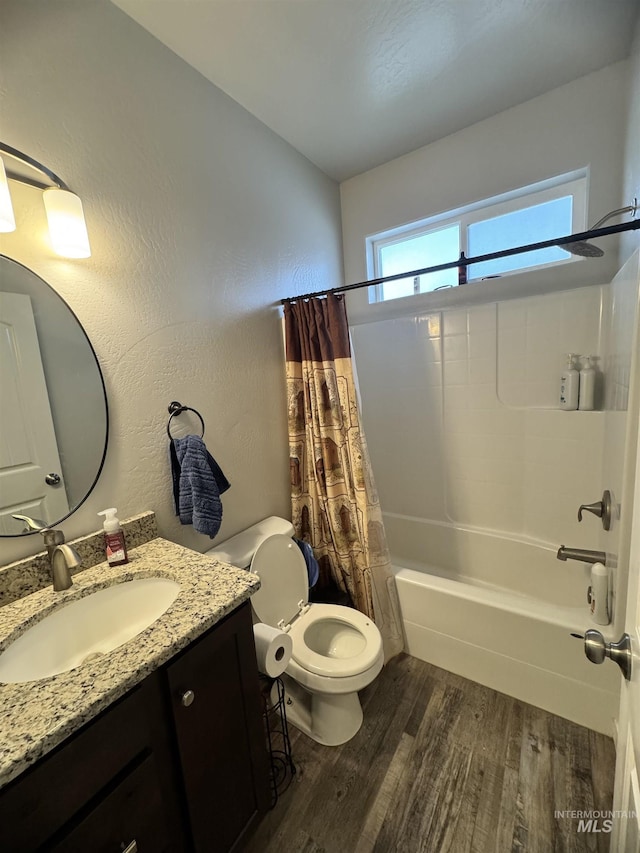 full bathroom with hardwood / wood-style floors, vanity, shower / bath combination with curtain, and toilet