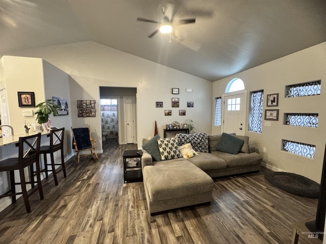 living room featuring dark hardwood / wood-style flooring, ceiling fan, plenty of natural light, and vaulted ceiling