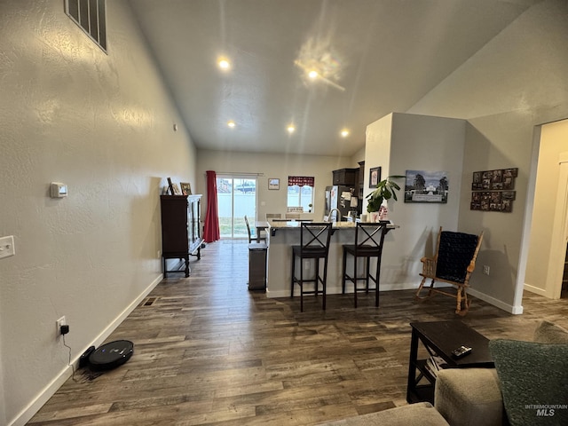 living room with lofted ceiling and dark wood-type flooring