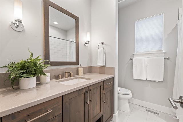 bathroom with tile patterned flooring, toilet, vanity, visible vents, and baseboards