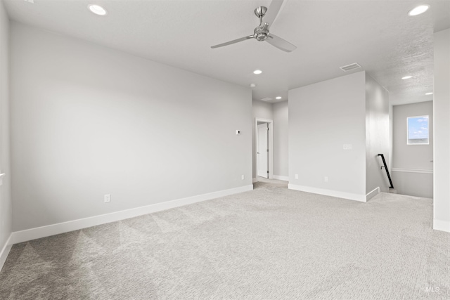 carpeted spare room with recessed lighting, visible vents, ceiling fan, and baseboards