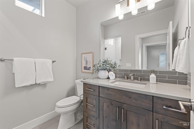 bathroom with baseboards, visible vents, toilet, tile patterned floors, and vanity