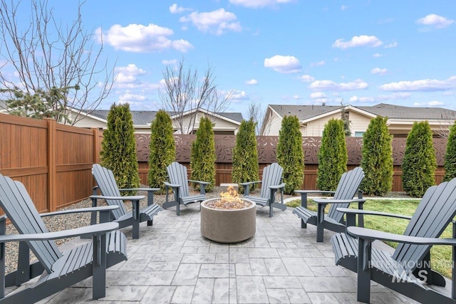 view of patio with a fire pit and a fenced backyard