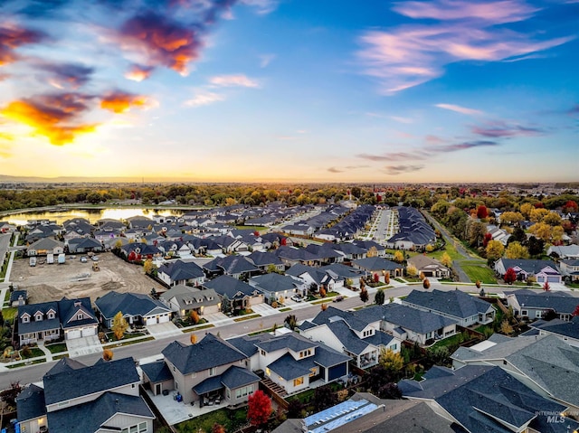 drone / aerial view featuring a water view and a residential view