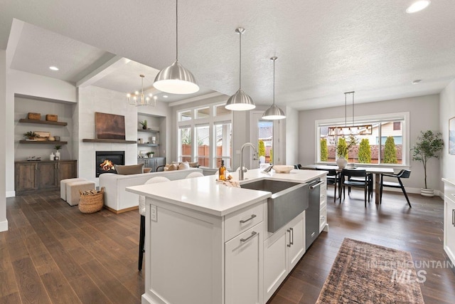 kitchen featuring a chandelier, dark wood-style floors, and dishwasher