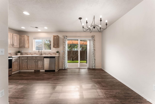 16170 Golddust Pl, Caldwell, ID 83607 - kitchen featuring appliances with stainless steel finishes, a chandelier, dark wood-type flooring, a textured ceiling, and light countertops