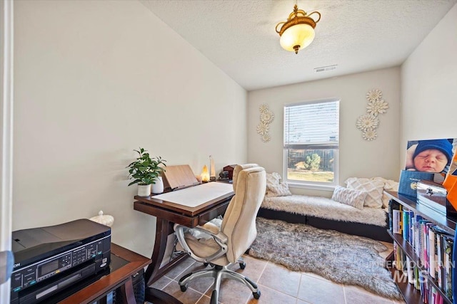 tiled home office featuring visible vents and a textured ceiling