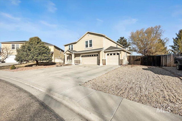 view of front of property featuring fence, stucco siding, concrete driveway, a garage, and stone siding