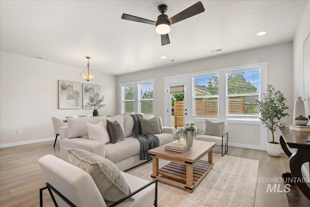 321 N Bay Haven Ave, Kuna, ID 83634 - living room featuring baseboards, a ceiling fan, light wood-style flooring, and recessed lighting
