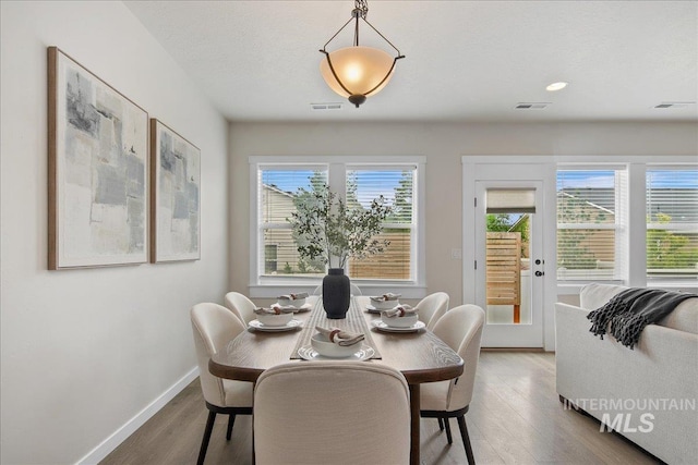 321 N Bay Haven Ave, Kuna, ID 83634 - dining space with healthy amount of natural light, wood finished floors, baseboards, and recessed lighting