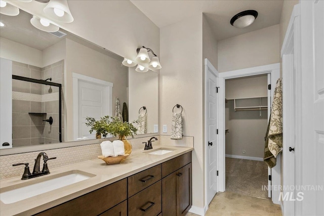 321 N Bay Haven Ave, Kuna, ID 83634 - bathroom with double vanity, decorative backsplash, a stall shower, a walk in closet, and baseboards