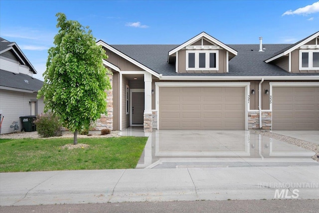 321 N Bay Haven Ave, Kuna, ID 83634 - view of front of home featuring stone siding, driveway, a garage, a front yard, and a shingled roof