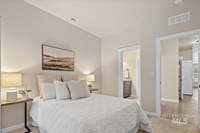 321 N Bay Haven Ave, Kuna, ID 83634 - bedroom with baseboards, carpet floors, and ensuite bath