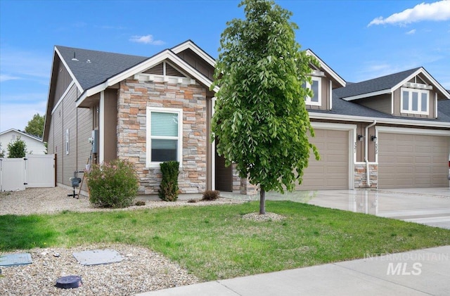 321 N Bay Haven Ave, Kuna, ID 83634 - craftsman-style house with stone siding, concrete driveway, roof with shingles, a garage, and a gate