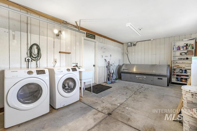 111 Main, Hagerman, ID 83332 - washroom featuring independent washer and dryer, wood walls, and a garage